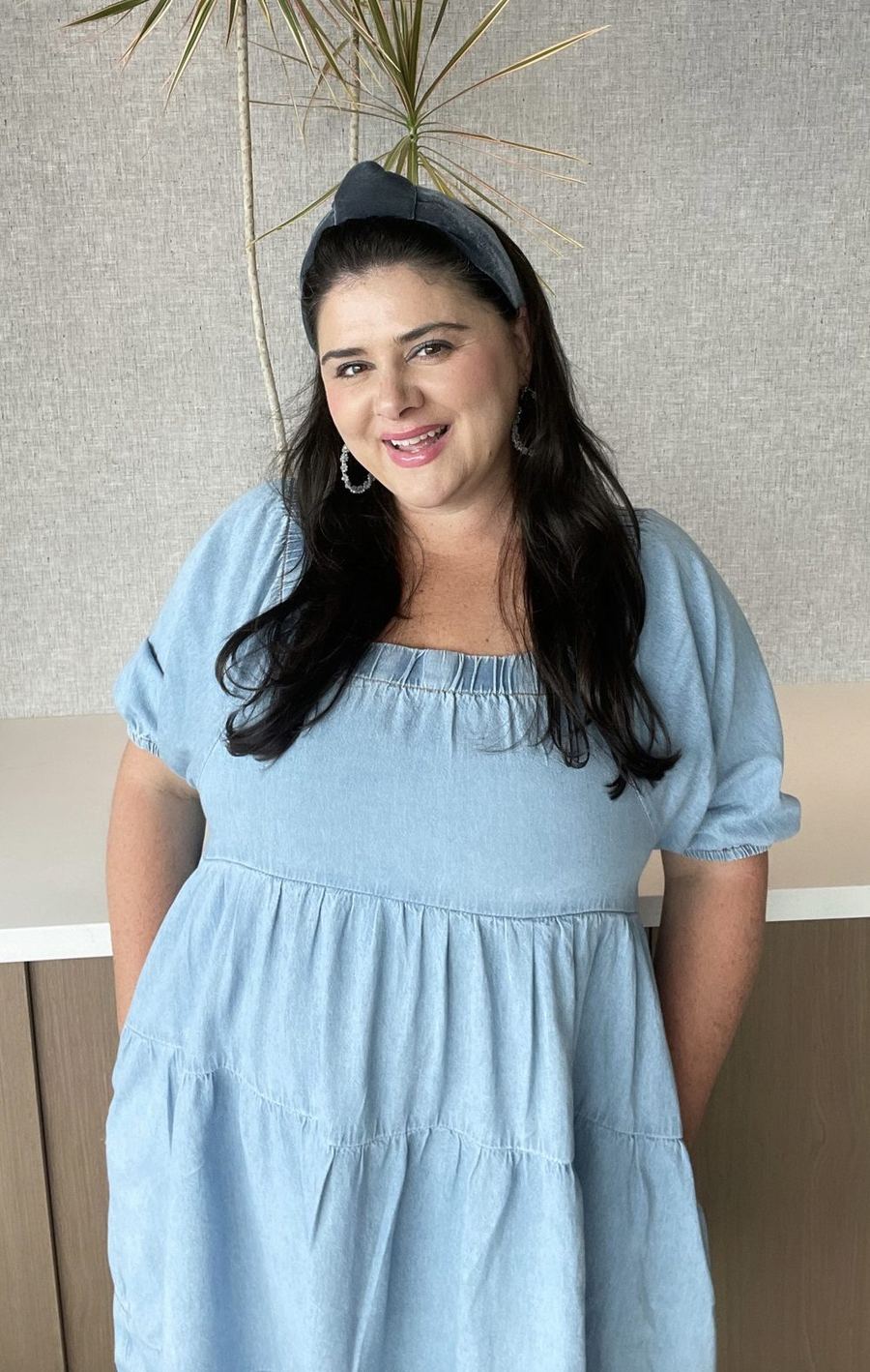Jacquelene Nigrelli smiling, in a light blue dress and headband